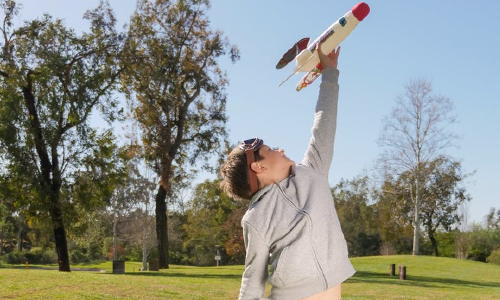 Boy playing freestyle game with rocket ship