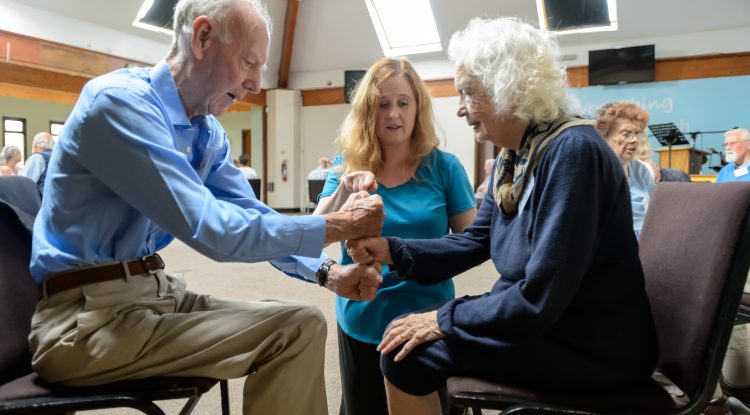 woman teaches older adults fitness