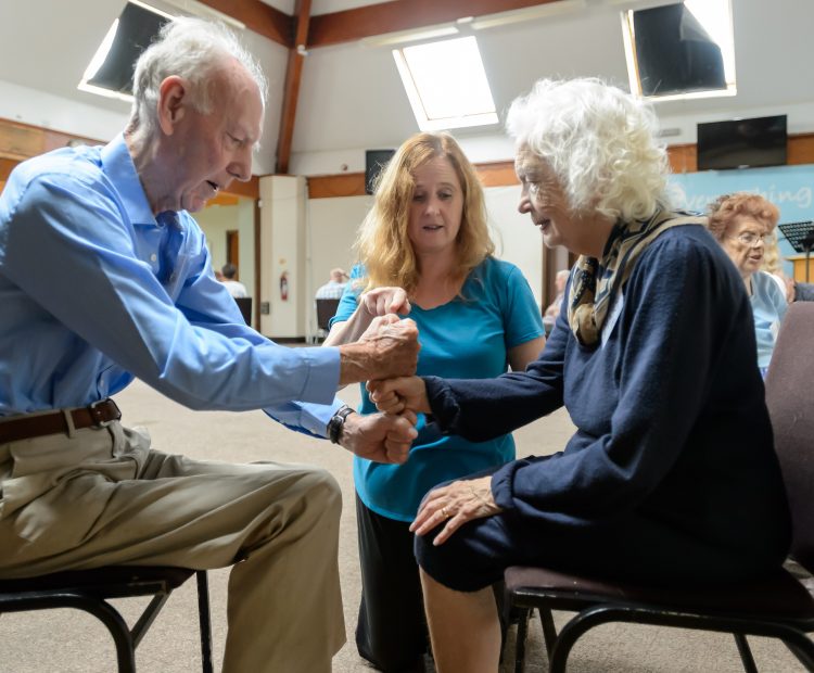 woman teaches older adults fitness