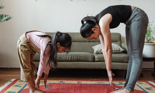 Woman and daughter stretching