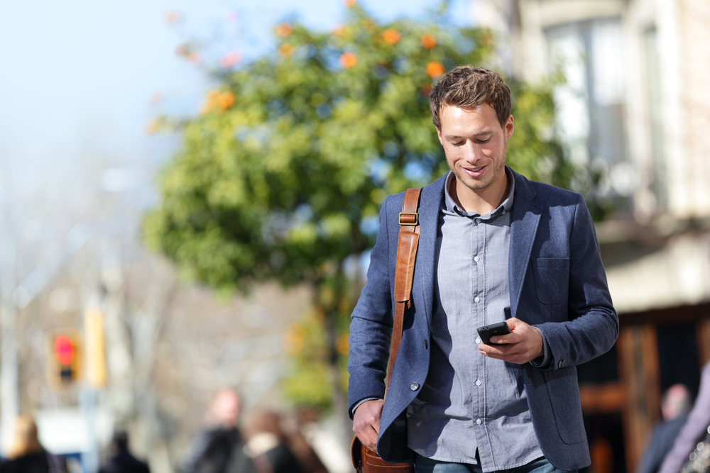 man walking and using phone