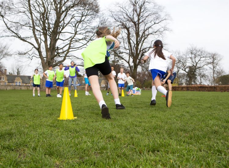 Kids running through sport cones