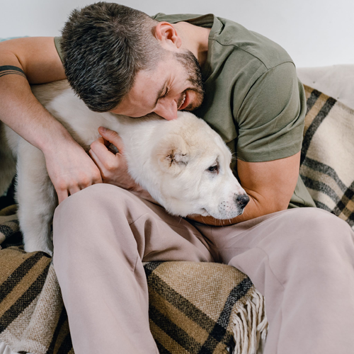 Man hugging dog