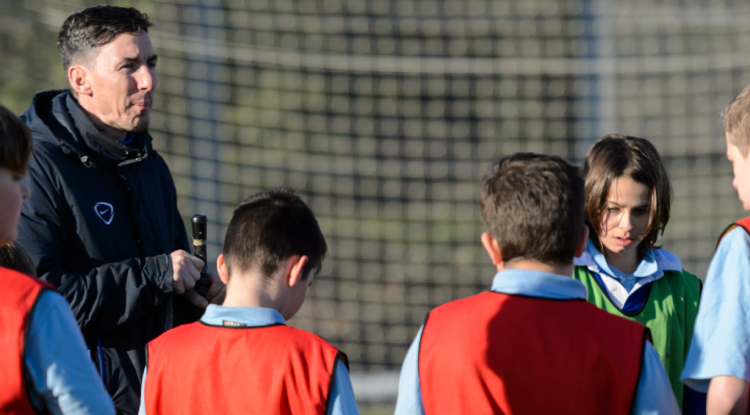 Man coaching group of children banner