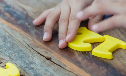 Child playing with plastic numbers