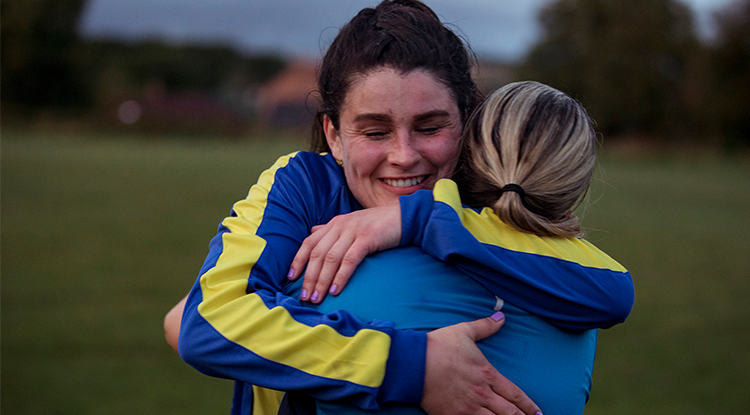 Two teammates embracing