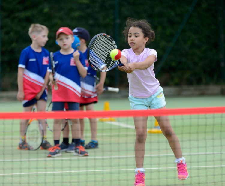 young girl playing tennis