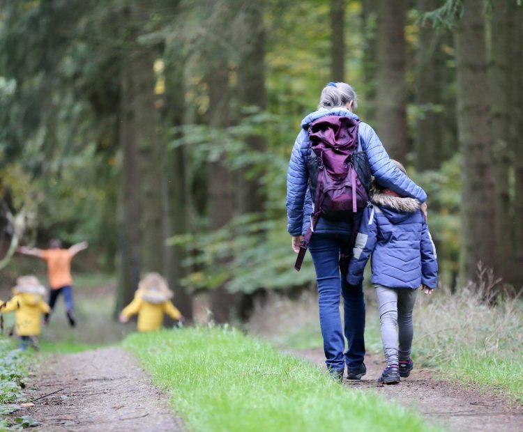 mother and children walking in forest