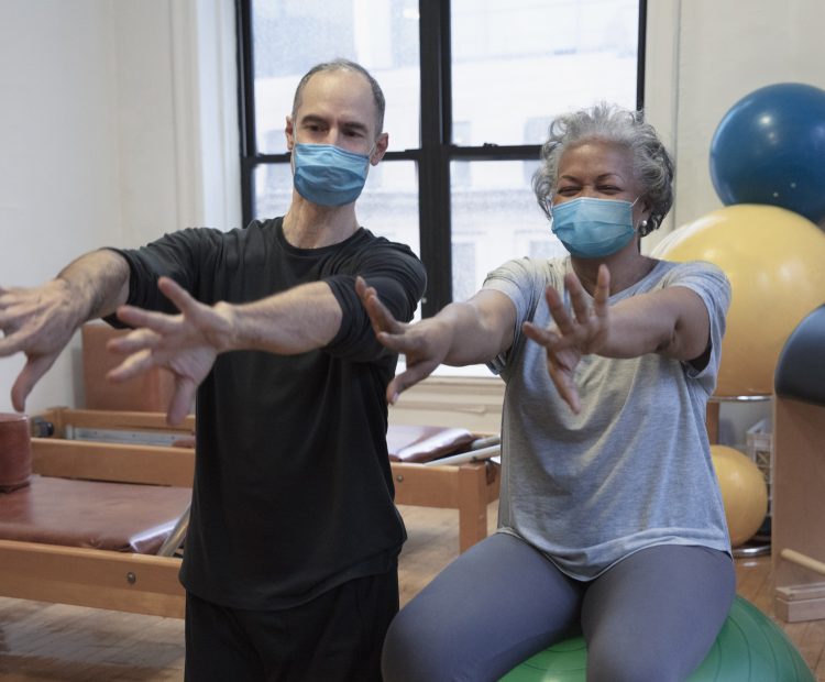 physio and woman exercising with masks