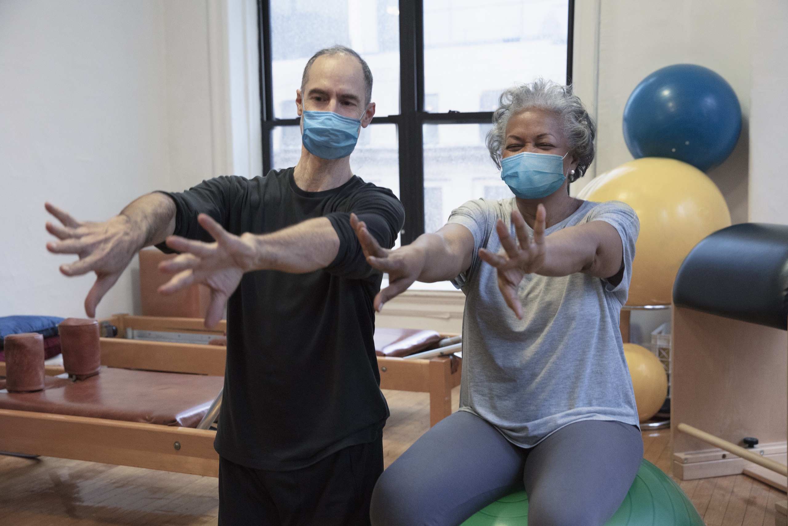 physio and woman exercising with masks