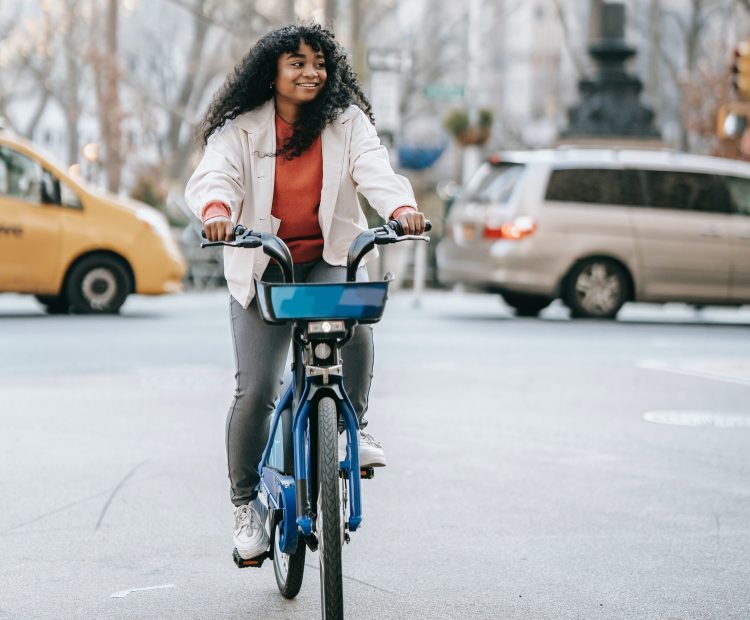 young woman on bike in city