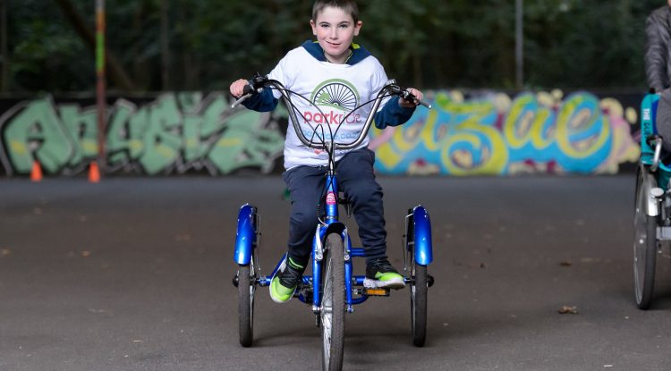 young boy on adapted bicycle