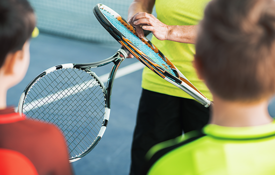 Tennis coach holding racket