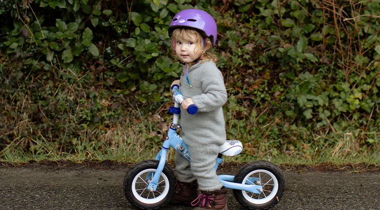 young child on balance bike