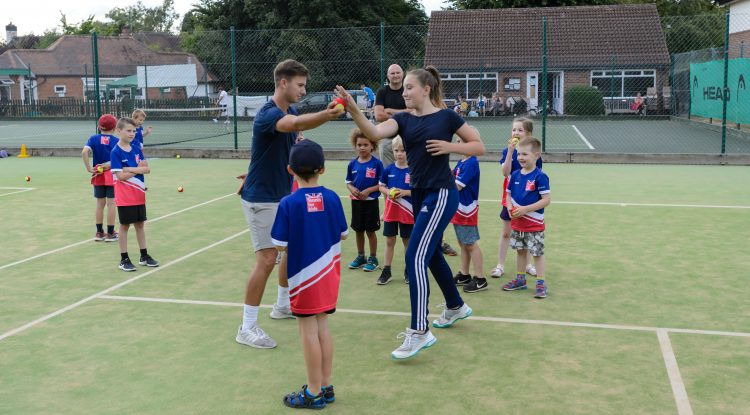 tennis coaching kids outdoors