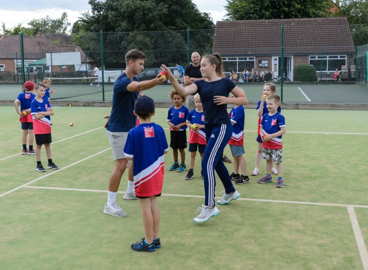 tennis coaching kids outdoors