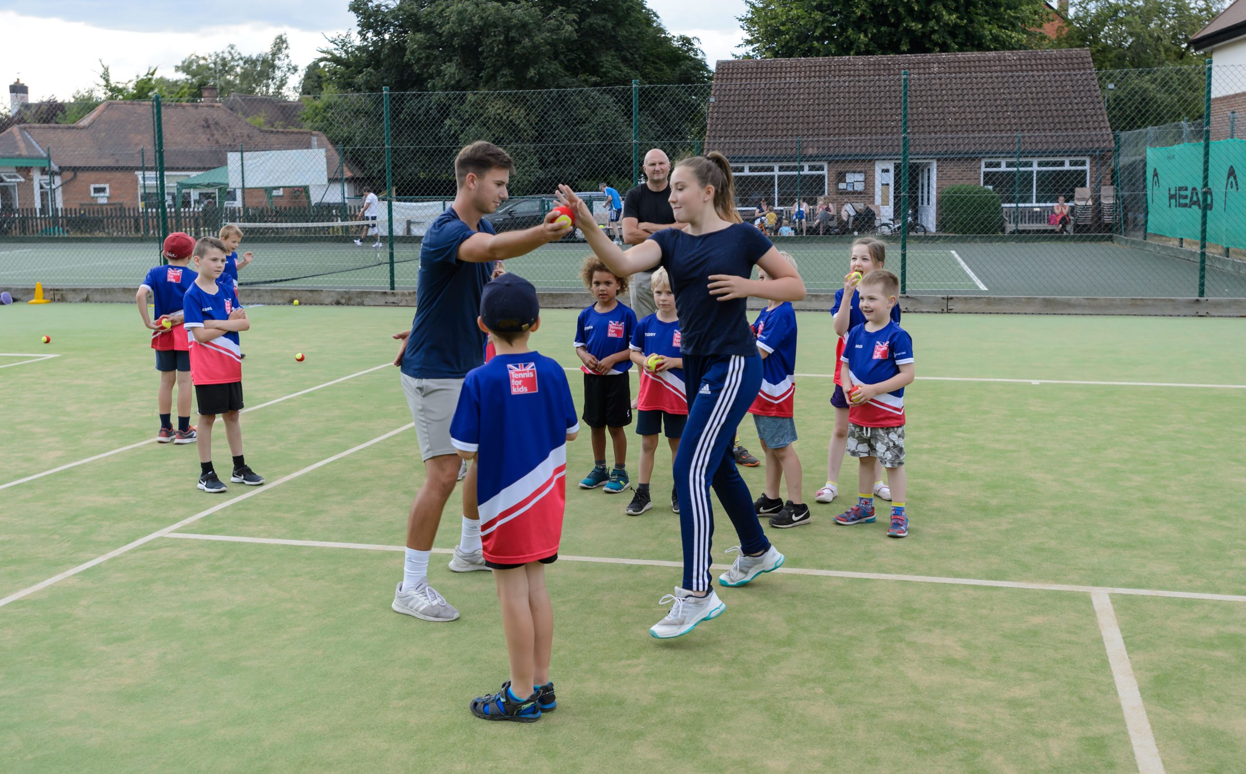 tennis coaching kids outdoors