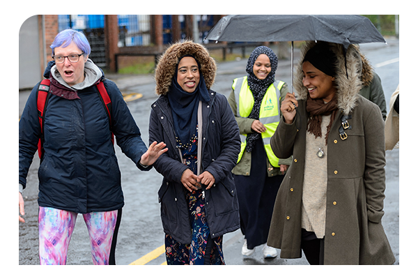 women walking for health in rain