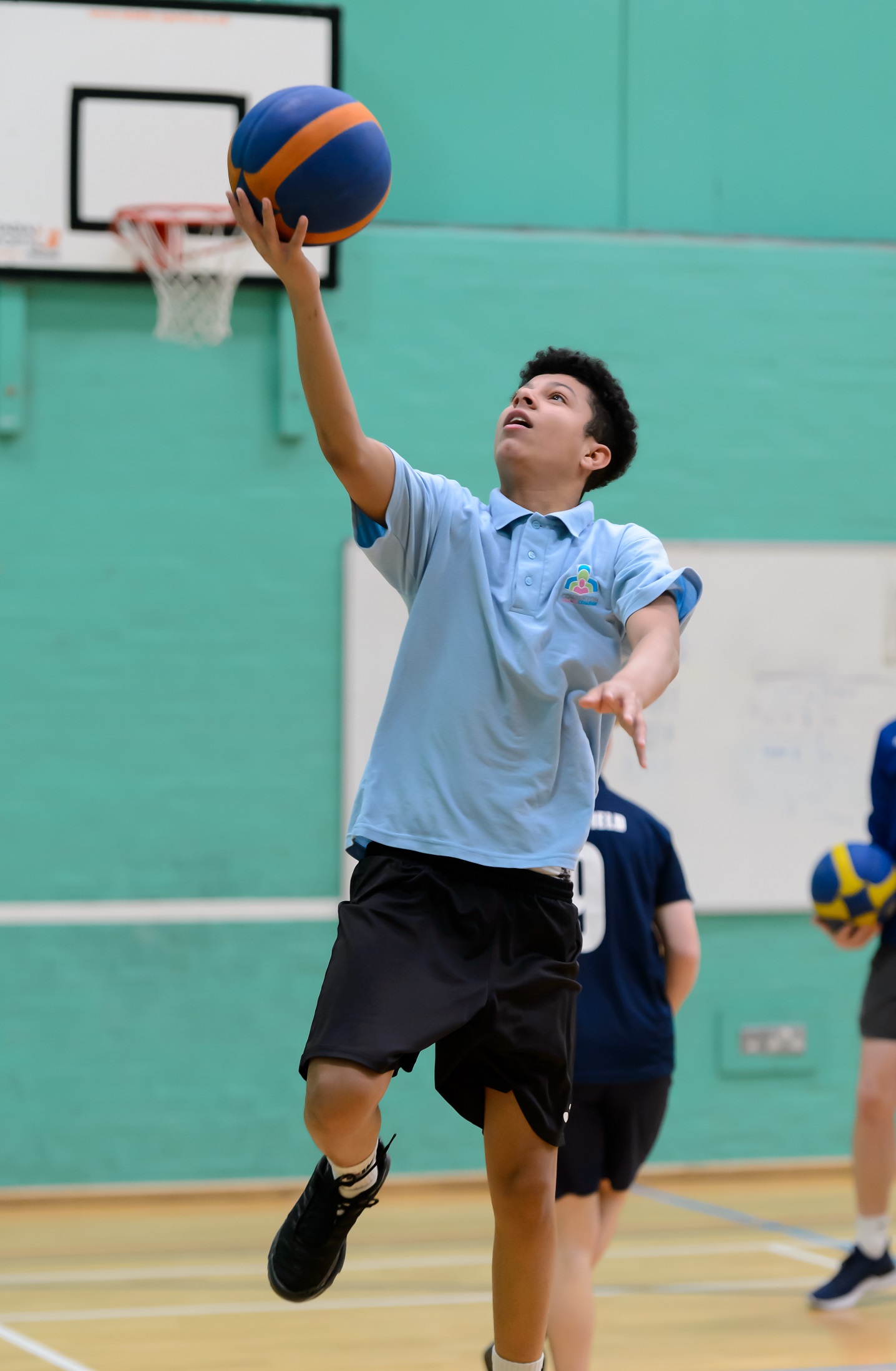 young man plays basketball