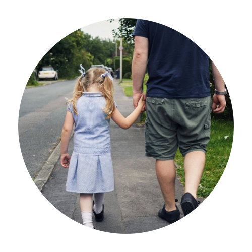 Dad and young daughter walking