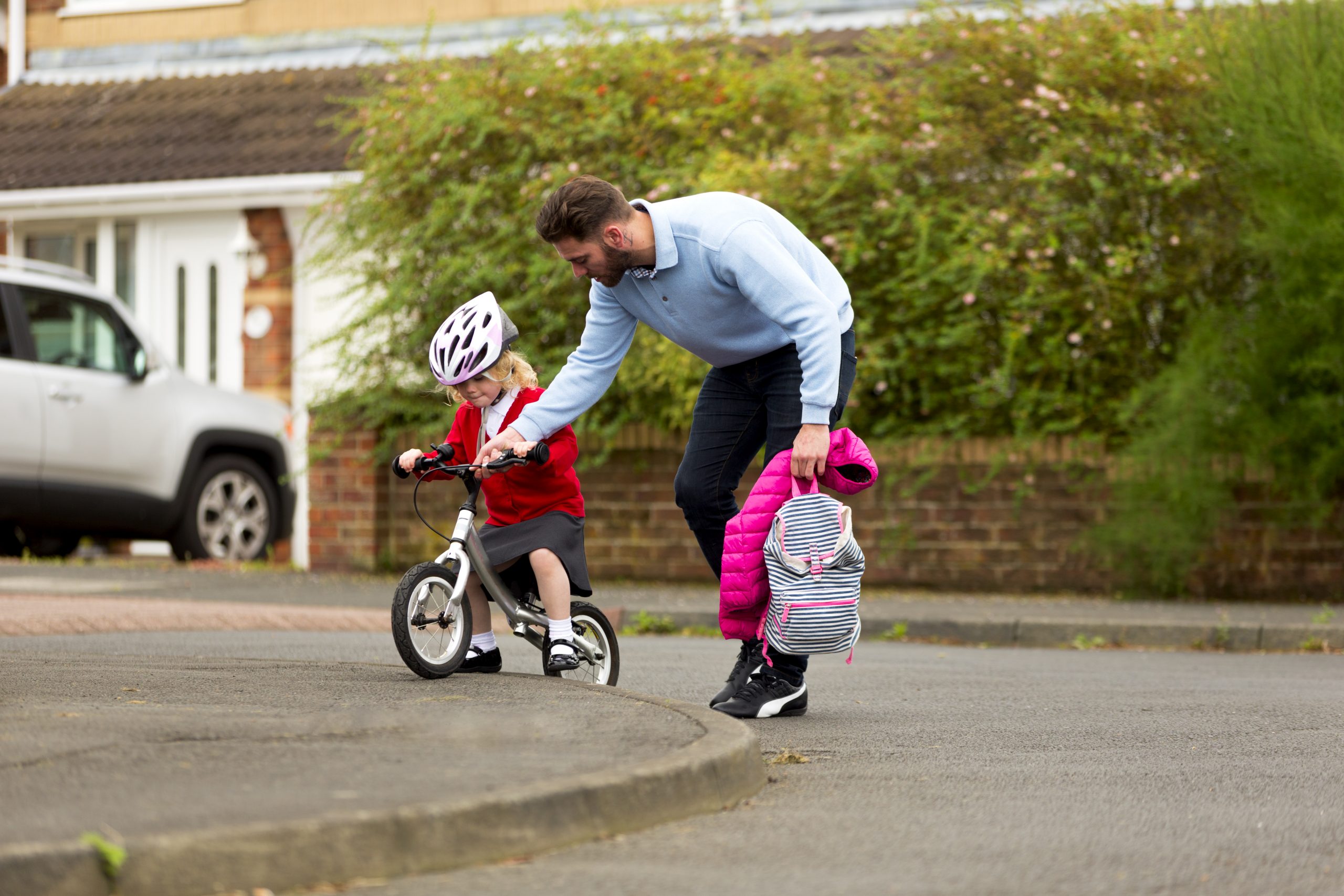 Father and daughter travelling actively to school