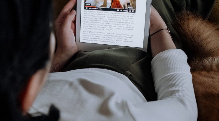 Lady on a tablet reading a newsletter